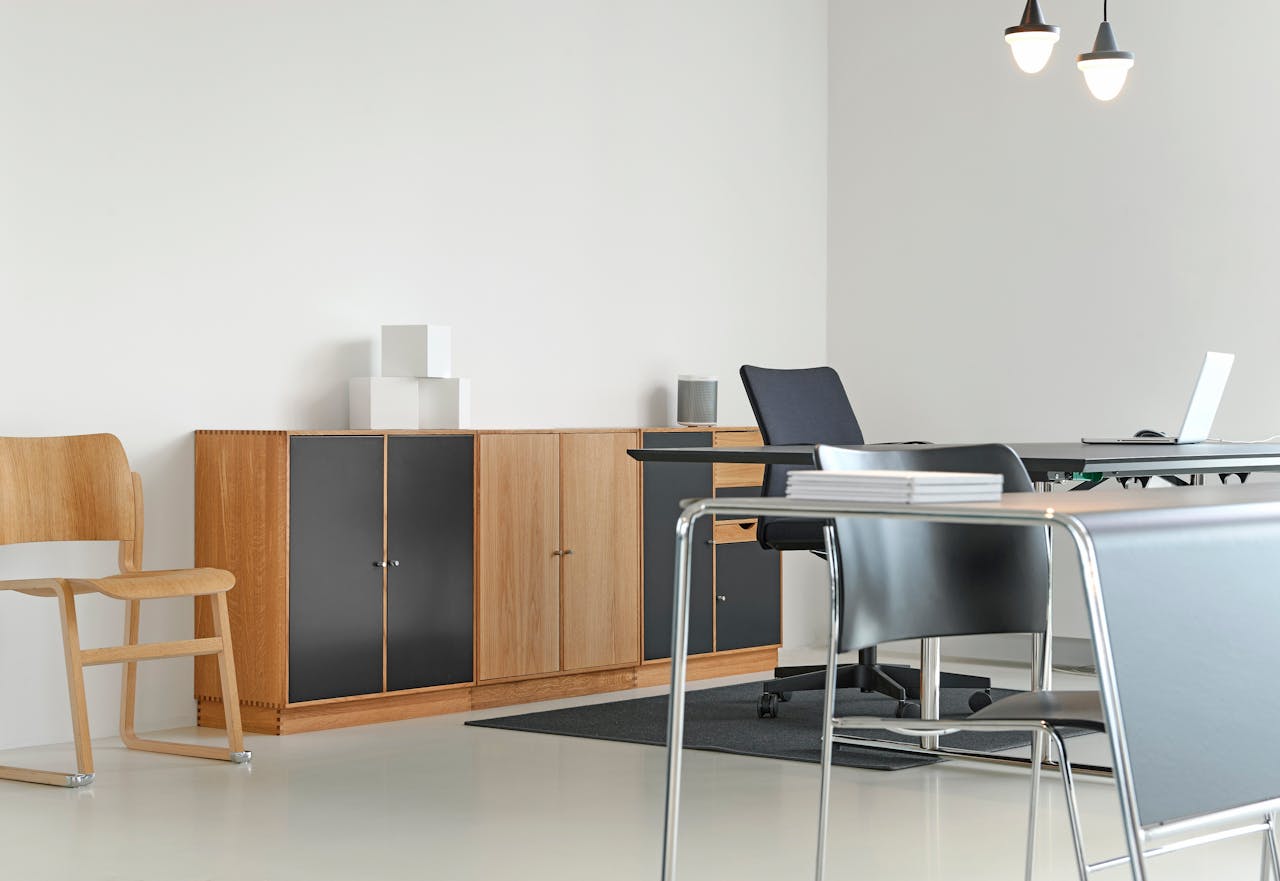 heros-img A clean and organized modern office space with stylish furniture and decor.